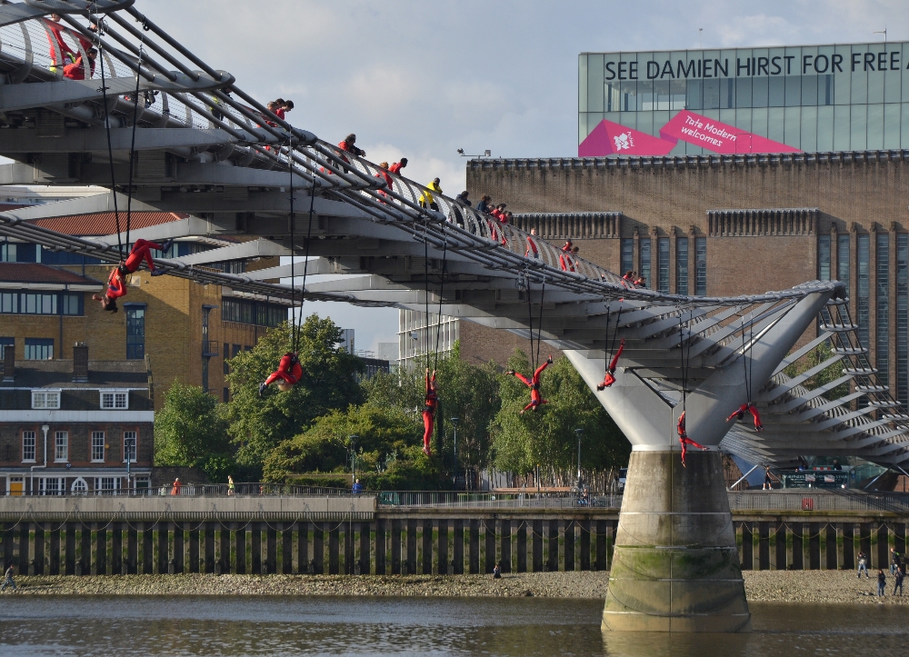 Waterfall, a dance performance by Elizabeth Streb at Millennium Bridge in front of Tate Modern. Streb's dancers performed acrobatic extreme-action aerial dance routines at seven surprises across central London as part of "one extraordinary day". Choreographed by Elizabeth Streb. Part of the London 2012 cultural Olympiad. Sunday 15 July 2012. © Michael Jones / Elizabeth Streb