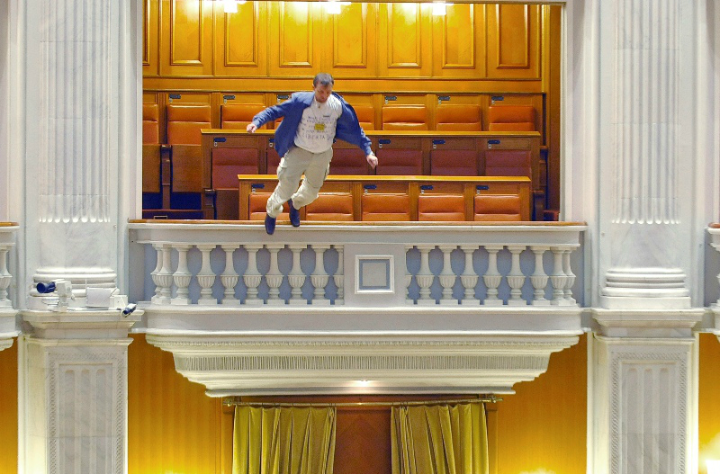 Adrian Sobaru, an electrician at the national television station, throws himself from a balcony in Romania's Parliament in protest against cuts of civil servant pay. AP Photo/Bogdan Stamatin/Mediafax Foto, 2010